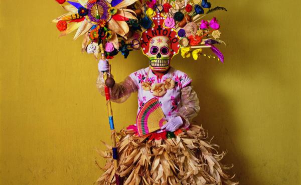 This costume, with corn husks and feathers and paper flowers, is worn by a member of a dance group that gathers in cemeteries and other places to mark Day of the Dead festivities (called Xantolo, the word written above the mask). The idea of combining a s This costume, with corn husks and feathers and paper flowers, is worn by a member of a dance group that gathers in cemeteries and other places to mark Day of the Dead festivities (called Xantolo, the word written above the mask). The idea of combining a s