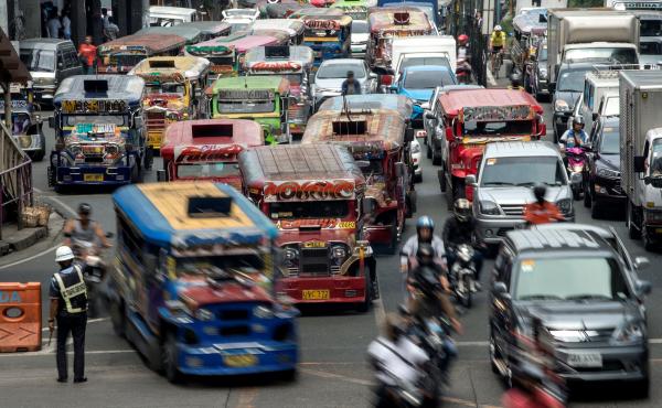 Jeepneys, often known in the Philippines as "King of the Road," join traffic on a busy street in Manila last May. Authorities are moving to phase them out, citing pollution and safety concerns. Jeepneys, often known in the Philippines as "King of the Road," join traffic on a busy street in Manila last May. Authorities are moving to phase them out, citing pollution and safety concerns.