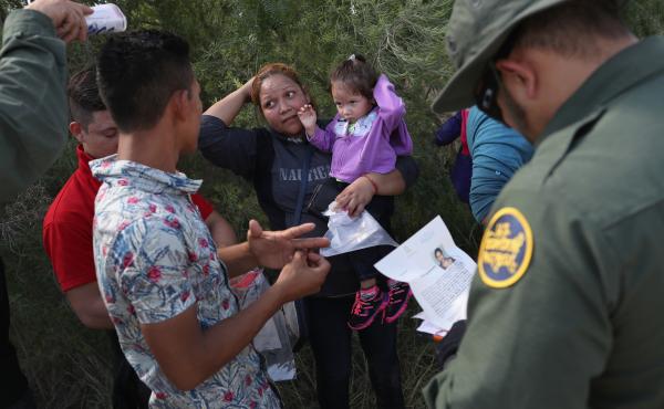 U.S. Border Patrol agents ask a group of Central American asylum seekers to remove hair bands and wedding rings before taking them into custody on June 12, near McAllen, Texas. U.S. Border Patrol agents ask a group of Central American asylum seekers to remove hair bands and wedding rings before taking them into custody on June 12, near McAllen, Texas.