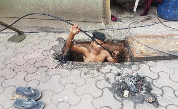 Jitesh Singolia, 19, climbs down a manhole to clean sewer pipes using his bare hands. Jitesh Singolia, 19, climbs down a manhole to clean sewer pipes using his bare hands.