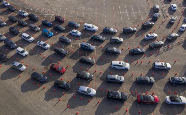 In an aerial view from a drone, cars line up at Dodger Stadium for COVID-19 testing in Los Angeles, California. In an aerial view from a drone, cars line up at Dodger Stadium for COVID-19 testing in Los Angeles, California.