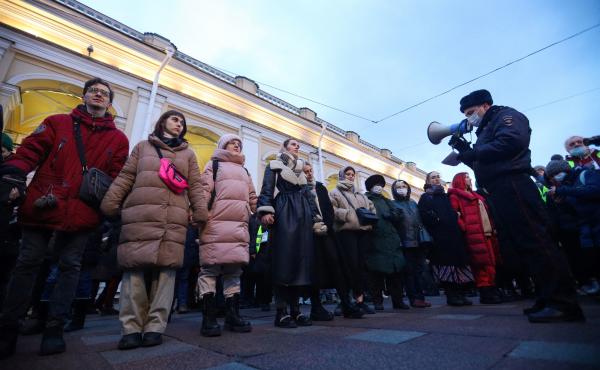 A police officer uses a loudspeaker to address people gathered in St. Petersburg to protest Russia's invasion of Ukraine on Feb. 24. A police officer uses a loudspeaker to address people gathered in St. Petersburg to protest Russia's invasion of Ukraine on Feb. 24.
