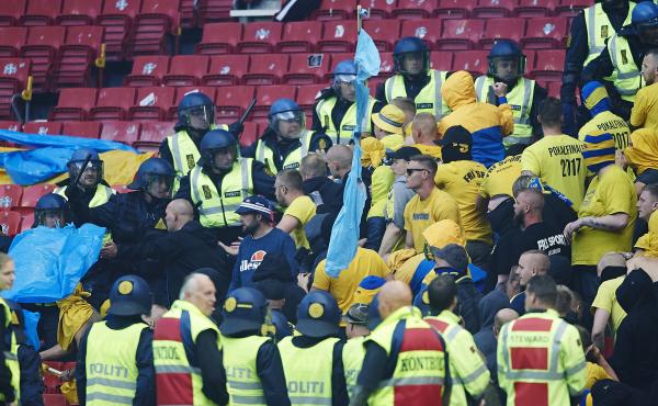 Brondby fans scuffle with police during a match between the Copenhagen and Brondby soccer teams at Copenhagen's Telia Parken stadium in 2017. Brondby fans scuffle with police during a match between the Copenhagen and Brondby soccer teams at Copenhagen's Telia Parken stadium in 2017.