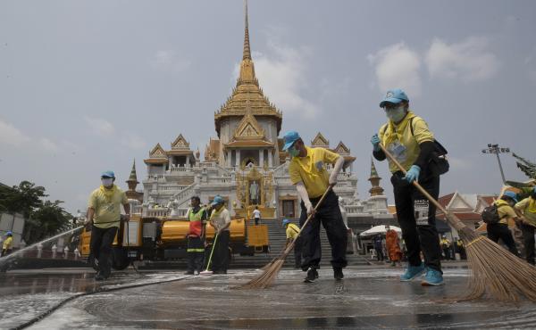 Volunteers clean as a precaution against the new coronavirus at Wat Traimit temple in Bangkok on Wednesday. Thailand's government has enacted stronger measures to combat the spread of COVID-19. Volunteers clean as a precaution against the new coronavirus at Wat Traimit temple in Bangkok on Wednesday. Thailand's government has enacted stronger measures to combat the spread of COVID-19.