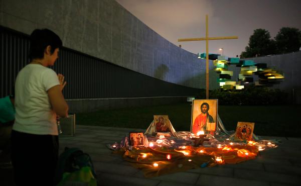 A student prays in front of a temporary altar during a rally outside government headquarters in Hong Kong on Sept. 24. A student prays in front of a temporary altar during a rally outside government headquarters in Hong Kong on Sept. 24.