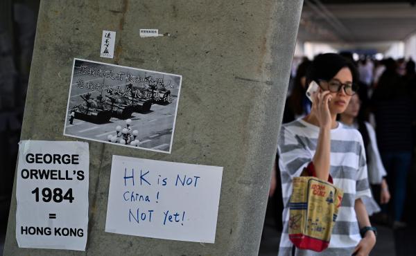 Placards against a controversial extradition law proposal pasted on a wall near the Legislative Council complex in Hong Kong on Friday. Placards against a controversial extradition law proposal pasted on a wall near the Legislative Council complex in Hong Kong on Friday.