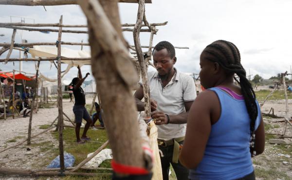 Felina Manita and her husband Jean are building a temporary home out of sticks after losing their home in Les Cayes in the earthquake on Saturday. Felina Manita and her husband Jean are building a temporary home out of sticks after losing their home in Les Cayes in the earthquake on Saturday.