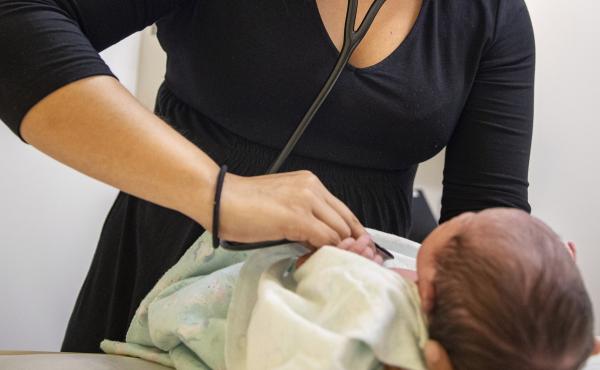 A pediatrician examines a newborn baby in her clinic in Chicago on Tuesday in 2019. In a new policy statement released Monday, the American Academy of Pediatrics says it is putting all its guidance under the microscope to eliminate "race-based" medicine a A pediatrician examines a newborn baby in her clinic in Chicago on Tuesday in 2019. In a new policy statement released Monday, the American Academy of Pediatrics says it is putting all its guidance under the microscope to eliminate "race-based" medicine a