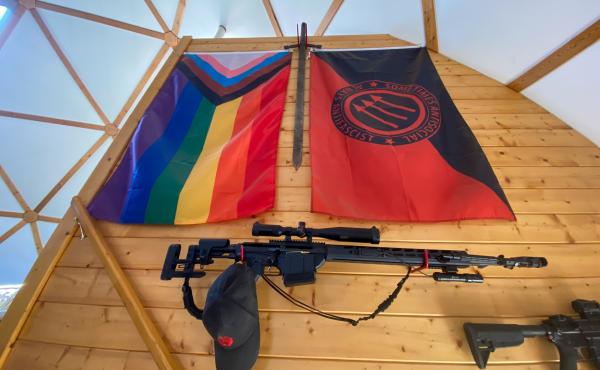 Various guns and flags adorn the wall leading up to the ranch house's second floor. Various guns and flags adorn the wall leading up to the ranch house's second floor.