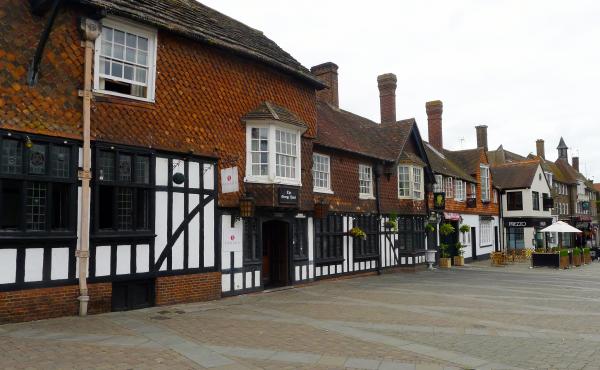 The George Hotel, a 17th century stagecoach inn, is one of the few historic buildings on Crawley's main street. Most of the town was built after World War II to house people displaced by bombing in London. In recent years, immigrants settled in Crawley an The George Hotel, a 17th century stagecoach inn, is one of the few historic buildings on Crawley's main street. Most of the town was built after World War II to house people displaced by bombing in London. In recent years, immigrants settled in Crawley an