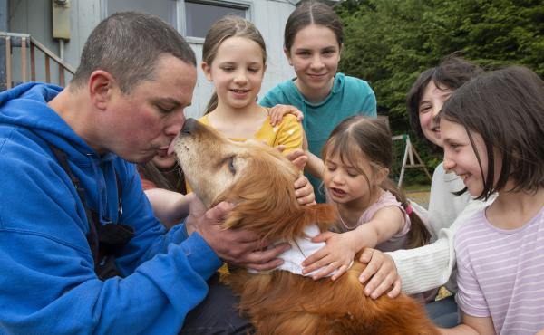 Ted Kubacki gets a lick from the family golden retriever, Lulu, outside their house after being reunited in Sitka, Alaska, on Thursday. The elderly, blind dog who had been missing three weeks, was found on Tuesday by a construction crew. Behind Kubacki is Ted Kubacki gets a lick from the family golden retriever, Lulu, outside their house after being reunited in Sitka, Alaska, on Thursday. The elderly, blind dog who had been missing three weeks, was found on Tuesday by a construction crew. Behind Kubacki is