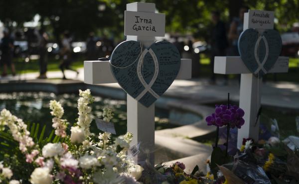 Messages are written on a cross honoring Irma Garcia, a teacher who was killed in this week's elementary school shooting, in Uvalde, Texas on Thursday. Messages are written on a cross honoring Irma Garcia, a teacher who was killed in this week's elementary school shooting, in Uvalde, Texas on Thursday.
