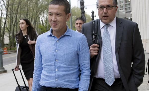Former Goldman Sachs executive Roger Ng (center) leaves Brooklyn federal court with attorney Marc Agnifilo on May 6, 2019, in New York. On Friday, Ng was convicted of bribery and other corruption charges accusing him of participating in a $4.5 billion sch Former Goldman Sachs executive Roger Ng (center) leaves Brooklyn federal court with attorney Marc Agnifilo on May 6, 2019, in New York. On Friday, Ng was convicted of bribery and other corruption charges accusing him of participating in a $4.5 billion sch