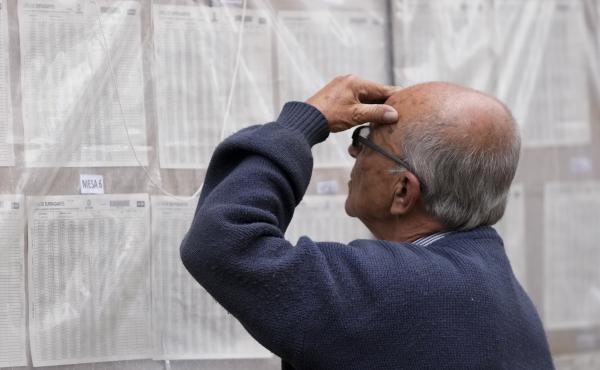 A man looks for his polling post during presidential elections in Bogota, Colombia, Sunday, May 29, 2022. A man looks for his polling post during presidential elections in Bogota, Colombia, Sunday, May 29, 2022.