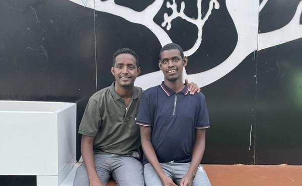 Omar Mohamed, left, and his brother, Hassan. In the graphic memoir he coauthored, When Stars Are Scattered, Mohamed shares what their life was like in the refugee camps in Kenya — and their journey to resettlement in the U.S. Omar Mohamed, left, and his brother, Hassan. In the graphic memoir he coauthored, When Stars Are Scattered, Mohamed shares what their life was like in the refugee camps in Kenya — and their journey to resettlement in the U.S.