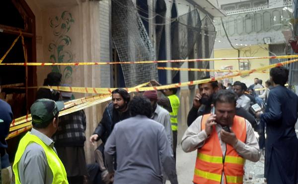 Rescue workers and volunteers gather at the site of bomb explosion in Peshawar, Pakistan, on Friday. Rescue workers and volunteers gather at the site of bomb explosion in Peshawar, Pakistan, on Friday.