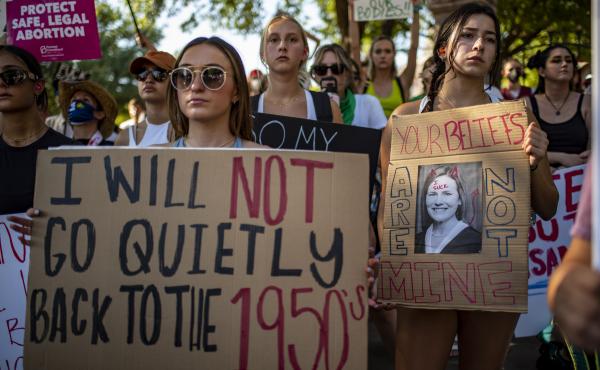 Protesters hold up signs during an abortion-rights rally on Saturday in Austin, Texas. Protesters hold up signs during an abortion-rights rally on Saturday in Austin, Texas.
