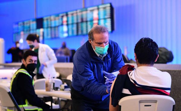 A pop-up clinic inside Los Angeles International Airport offered free vaccinations and boosters for holiday travelers last December. A new round of vaccinations may be needed before next winter. A pop-up clinic inside Los Angeles International Airport offered free vaccinations and boosters for holiday travelers last December. A new round of vaccinations may be needed before next winter.