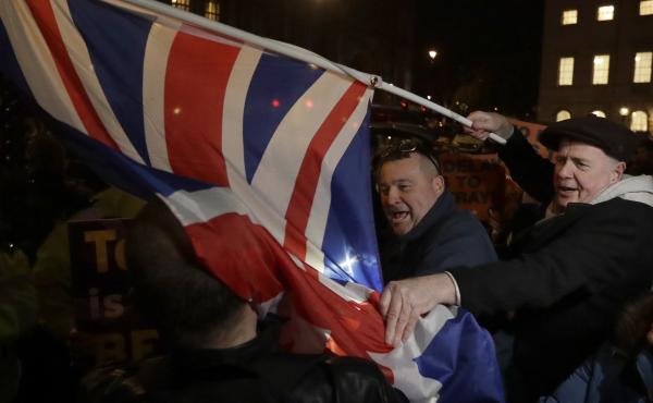 Brexit supporters and opponents shout at each other outside Parliament in London on Thursday, the day that British lawmakers voted to delay Brexit. Brexit supporters and opponents shout at each other outside Parliament in London on Thursday, the day that British lawmakers voted to delay Brexit.