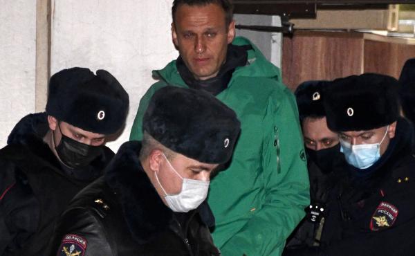 Opposition leader Alexei Navalny is escorted out of a police station in Khimki, outside Moscow, following the court ruling that ordered him jailed for 30 days. Opposition leader Alexei Navalny is escorted out of a police station in Khimki, outside Moscow, following the court ruling that ordered him jailed for 30 days.