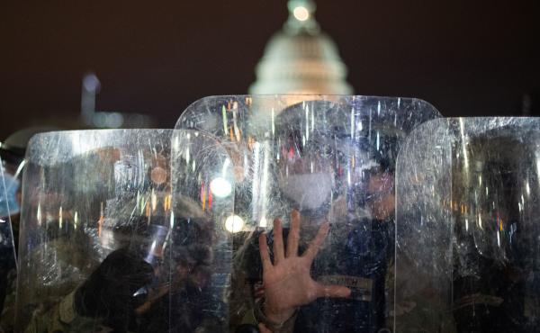 National Guard troops stand behind shields outside the Capitol building in Washington, D.C., on Wednesday evening. National Guard troops stand behind shields outside the Capitol building in Washington, D.C., on Wednesday evening.