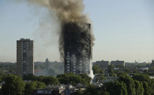 Smoke rises from the Grenfell Tower in west London on Wednesday. A massive fire raced through the 24-story high-rise apartment building overnight. Smoke rises from the Grenfell Tower in west London on Wednesday. A massive fire raced through the 24-story high-rise apartment building overnight.