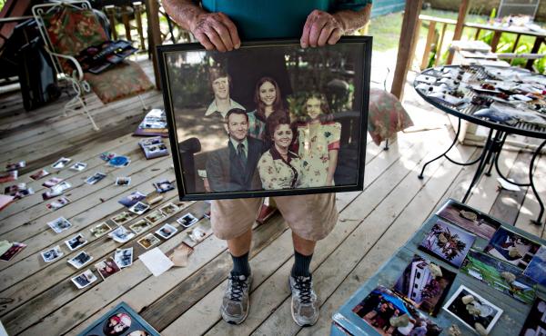 Hilton Pray, 82, holds one of thousands of his photographs that were damaged after an estimated 4-feet of water filled his home in Denham Springs, La. Hilton Pray, 82, holds one of thousands of his photographs that were damaged after an estimated 4-feet of water filled his home in Denham Springs, La.