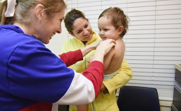 Marbell Castillo held her granddaughter, Maia Powell, as she was being examined by nurse practitioner Molly Lalonde at Burke Pediatrics in Burke, Va., in October 2017. Maia is insured through Virginia's Children's Health Insurance Program. Marbell Castillo held her granddaughter, Maia Powell, as she was being examined by nurse practitioner Molly Lalonde at Burke Pediatrics in Burke, Va., in October 2017. Maia is insured through Virginia's Children's Health Insurance Program.