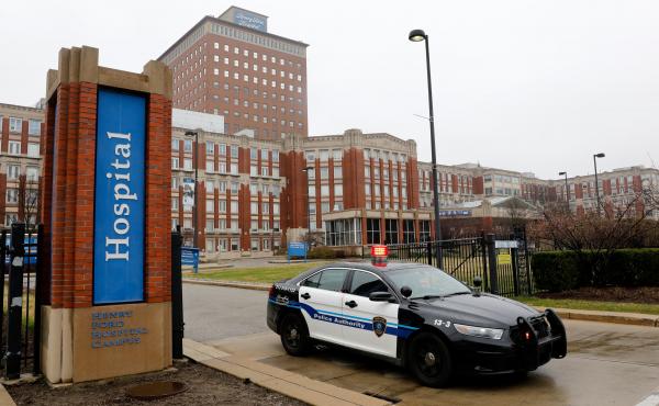 More than 2,600 health care workers in the Detroit area either have been out sick with symptoms similar to those of COVID-19 or have tested positive for the coronavirus. Above, a police car leaves Henry Ford Hospital in Detroit on April 7. More than 2,600 health care workers in the Detroit area either have been out sick with symptoms similar to those of COVID-19 or have tested positive for the coronavirus. Above, a police car leaves Henry Ford Hospital in Detroit on April 7.