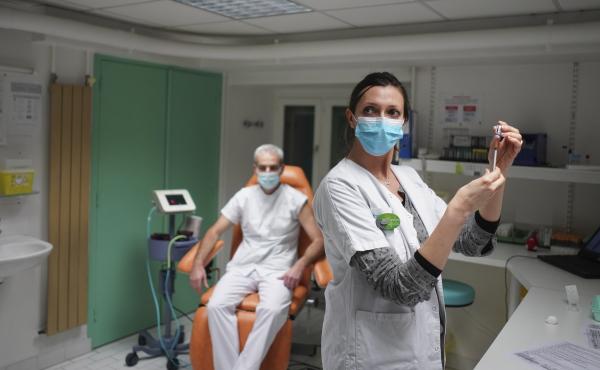 A nurse prepares to administer the Pfizer-BioNTech COVID-19 vaccine to Dr. Jean-Christophe Richard in La Croix-Rousse hospital, in Lyon, France, on Wednesday. Amid public outcry, France's health minister promised Tuesday an "exponential" acceleration of h A nurse prepares to administer the Pfizer-BioNTech COVID-19 vaccine to Dr. Jean-Christophe Richard in La Croix-Rousse hospital, in Lyon, France, on Wednesday. Amid public outcry, France's health minister promised Tuesday an "exponential" acceleration of h
