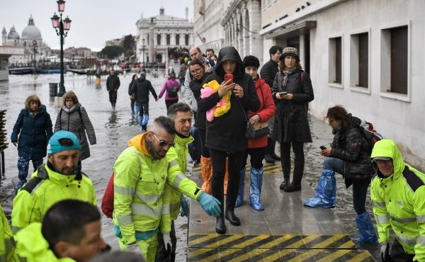 Volunteers set up a footbridge across Venice's flooded Riva degli Schiavoni embankment on Nov. 13. Volunteers set up a footbridge across Venice's flooded Riva degli Schiavoni embankment on Nov. 13.