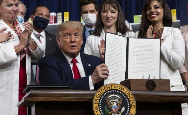 President Trump holds up a signed executive order on lowering drug prices on July 24. President Trump holds up a signed executive order on lowering drug prices on July 24.