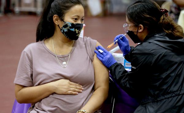 A woman receives a Pfizer vaccination booster shot from a nurse in Los Angeles. California Department of Public Health officials say that no fully vaccinated adult should be denied a COVID-19 booster shot in the state. A woman receives a Pfizer vaccination booster shot from a nurse in Los Angeles. California Department of Public Health officials say that no fully vaccinated adult should be denied a COVID-19 booster shot in the state.