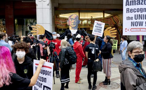 Workers and supporters hold signs after filing a petition requesting an election to form a union outside the National Labor Relations Board (NLRB) regional office in the Brooklyn Borough of New York, U.S., on Monday, Oct. 25, 2021. Amazon.com Inc. workers Workers and supporters hold signs after filing a petition requesting an election to form a union outside the National Labor Relations Board (NLRB) regional office in the Brooklyn Borough of New York, U.S., on Monday, Oct. 25, 2021. Amazon.com Inc. workers