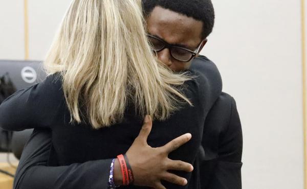 Botham Jean's younger brother, Brandt Jean, hugs former Dallas police officer Amber Guyger after delivering his victim-impact statement. Guyger was convicted for Botham Jean's murder on Tuesday and was sentenced to 10 years in prison on Wednesday. Botham Jean's younger brother, Brandt Jean, hugs former Dallas police officer Amber Guyger after delivering his victim-impact statement. Guyger was convicted for Botham Jean's murder on Tuesday and was sentenced to 10 years in prison on Wednesday.