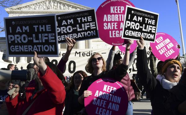 Protesters on both sides of the abortion issue gather outside the Supreme Court in Washington on Jan. 19 during the March for Life. Protesters on both sides of the abortion issue gather outside the Supreme Court in Washington on Jan. 19 during the March for Life.