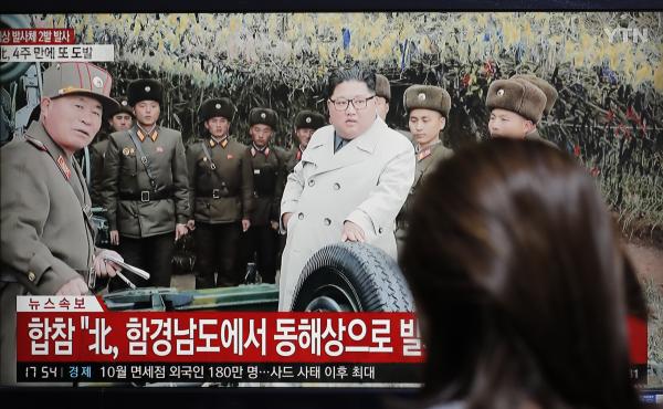A woman watches a news program showing North Korean leader Kim Jong Un. A woman watches a news program showing North Korean leader Kim Jong Un.
