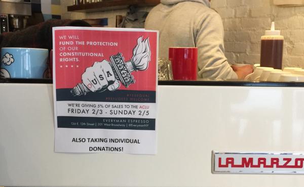 At Everyman Espresso in New York City's East Village, customers were greeted with a sign announcing a fundraiser to help defend immigrants. At Everyman Espresso in New York City's East Village, customers were greeted with a sign announcing a fundraiser to help defend immigrants.