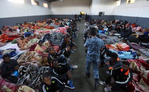 African migrants sitting in a shelter at the Tariq Al-Matar migrant detention center on the outskirts of the Libyan capital, Tripoli, on Monday. African migrants sitting in a shelter at the Tariq Al-Matar migrant detention center on the outskirts of the Libyan capital, Tripoli, on Monday.
