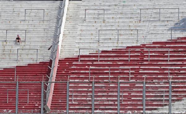 A River Plate fan sits on an empty stand at the Monumental Stadium in Buenos Aires, after the all-Argentine Copa Libertadores second leg final match against Boca Juniors was postponed on Sunday for the second time following an attack on the Boca team bus A River Plate fan sits on an empty stand at the Monumental Stadium in Buenos Aires, after the all-Argentine Copa Libertadores second leg final match against Boca Juniors was postponed on Sunday for the second time following an attack on the Boca team bus