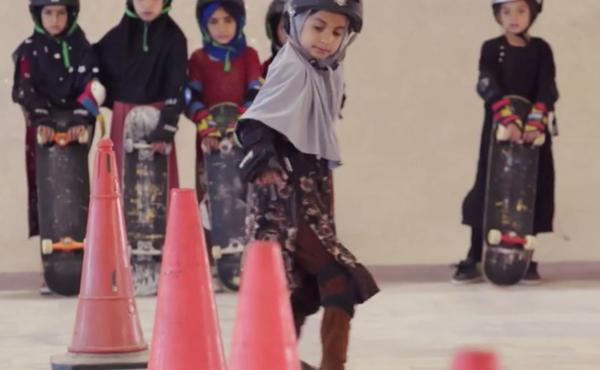 Students wearing headscarves and helmets learn to navigate traffic cones in a scene from the Oscar-winning documentary, "Learning to Skateboard in a Warzone (If You're a Girl)." Students wearing headscarves and helmets learn to navigate traffic cones in a scene from the Oscar-winning documentary, "Learning to Skateboard in a Warzone (If You're a Girl)."