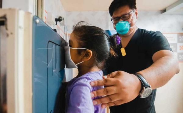 A young girl waits as her chest X-ray is taken in a TB Móvil van clinic in Lima, Peru. A young girl waits as her chest X-ray is taken in a TB Móvil van clinic in Lima, Peru.