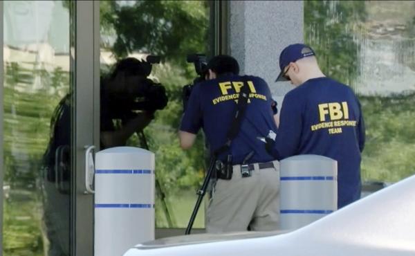 FBI agents document evidence outside a bureau field office in Kenwood, Ohio, on Aug. 11, after an armed man tried to breach the building. He fled and was later killed by law enforcement, authorities said. FBI agents document evidence outside a bureau field office in Kenwood, Ohio, on Aug. 11, after an armed man tried to breach the building. He fled and was later killed by law enforcement, authorities said.