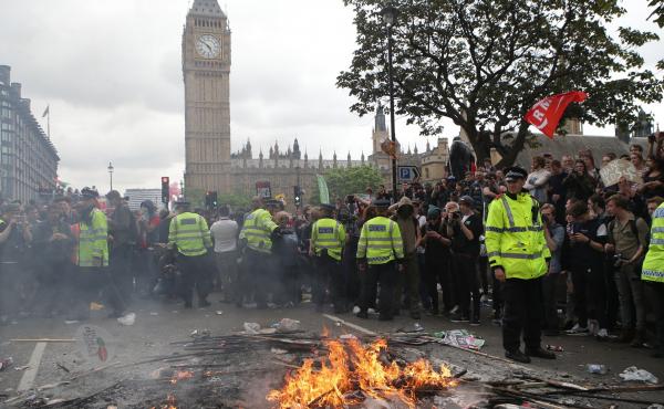 Placards are burned at the End Austerity Now rally in Parliament Square, London. Protesters have said the march was the start of a broader campaign to end government cuts to social programs. Placards are burned at the End Austerity Now rally in Parliament Square, London. Protesters have said the march was the start of a broader campaign to end government cuts to social programs.