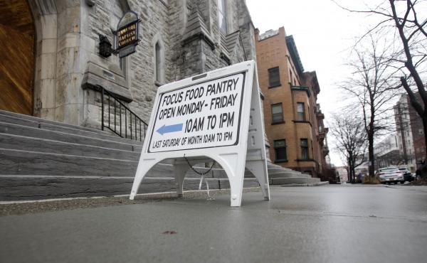 A sign sits on a sidewalk outside the Interfaith Food Pantry at Emmanuel Baptist Church in February in Albany, N.Y. Congress may be under more pressure than usual to cut safety net spending — health care, housing assistance, welfare and food aid — to A sign sits on a sidewalk outside the Interfaith Food Pantry at Emmanuel Baptist Church in February in Albany, N.Y. Congress may be under more pressure than usual to cut safety net spending — health care, housing assistance, welfare and food aid — to