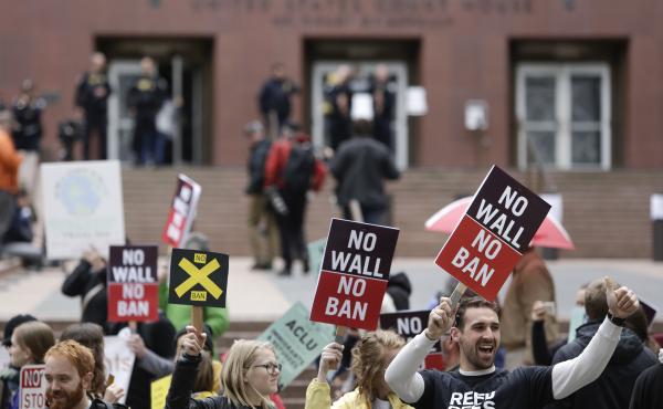 People protest outside as the 9th U.S. Circuit Court of Appeals prepares to hear arguments on President Trump's revised travel ban in Seattle on Monday. People protest outside as the 9th U.S. Circuit Court of Appeals prepares to hear arguments on President Trump's revised travel ban in Seattle on Monday.