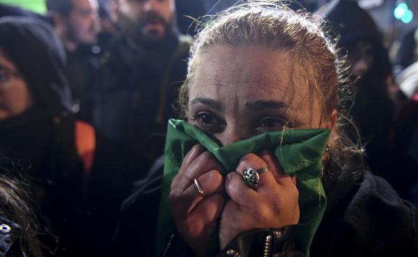 An abortion-rights activist reacts outside the National Congress in Buenos Aires, on Thursday to news that the Senate voted to reject a bill that would have legalized abortion. An abortion-rights activist reacts outside the National Congress in Buenos Aires, on Thursday to news that the Senate voted to reject a bill that would have legalized abortion.