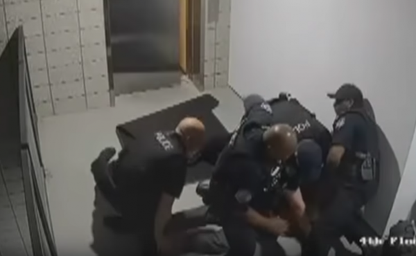 A still from surveillance footage, released by the police department in Mesa, Ariz., shows officers surrounding a man after they punched him to the ground. A still from surveillance footage, released by the police department in Mesa, Ariz., shows officers surrounding a man after they punched him to the ground.