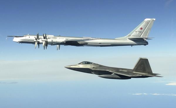In this image taken June 16, 2020, and released by the North American Aerospace Defense Command, a Russian Tu-95 bomber (top) is intercepted by a U.S. F-22 Raptor fighter off the coast of Alaska. Russian nuclear-capable strategic bombers have flown near A In this image taken June 16, 2020, and released by the North American Aerospace Defense Command, a Russian Tu-95 bomber (top) is intercepted by a U.S. F-22 Raptor fighter off the coast of Alaska. Russian nuclear-capable strategic bombers have flown near A
