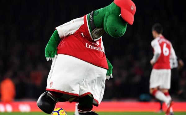 Gunnersaurus is seen warming up prior to a match at Emirates Stadium in 2017 in London. Jerry Quy, who played the team's mascot Gunnersaurus for 27 years, was recently told he would be let go. Gunnersaurus is seen warming up prior to a match at Emirates Stadium in 2017 in London. Jerry Quy, who played the team's mascot Gunnersaurus for 27 years, was recently told he would be let go.
